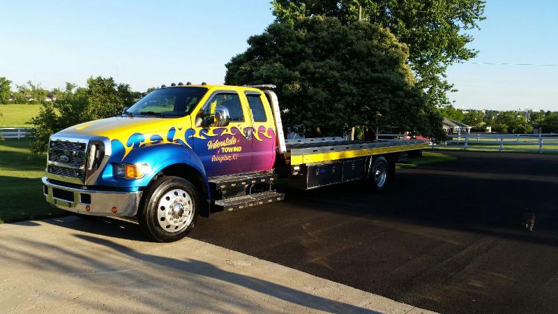 yellow flatbed tow truck